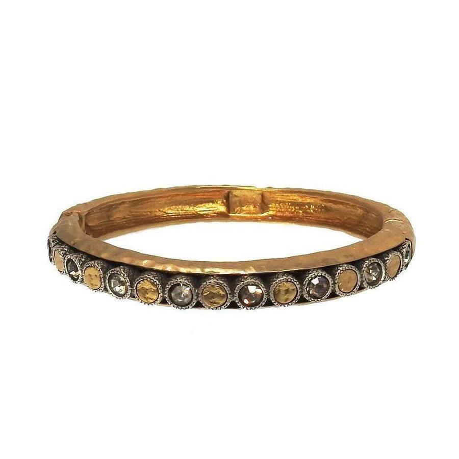 Gold hinged bangle bracelet with crystal accents.