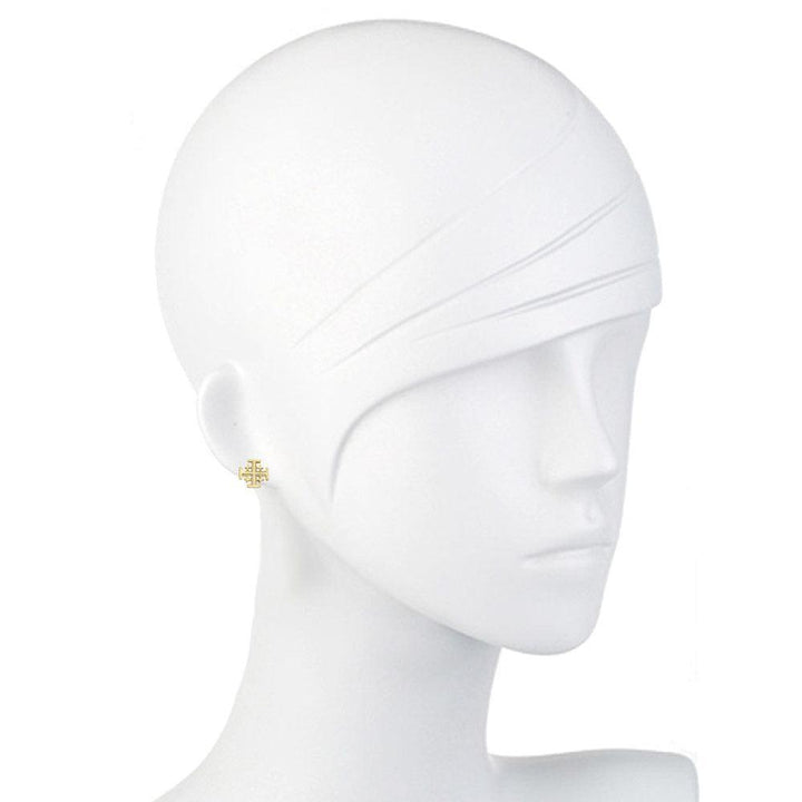 Gold cross stud earrings on a mannequin.