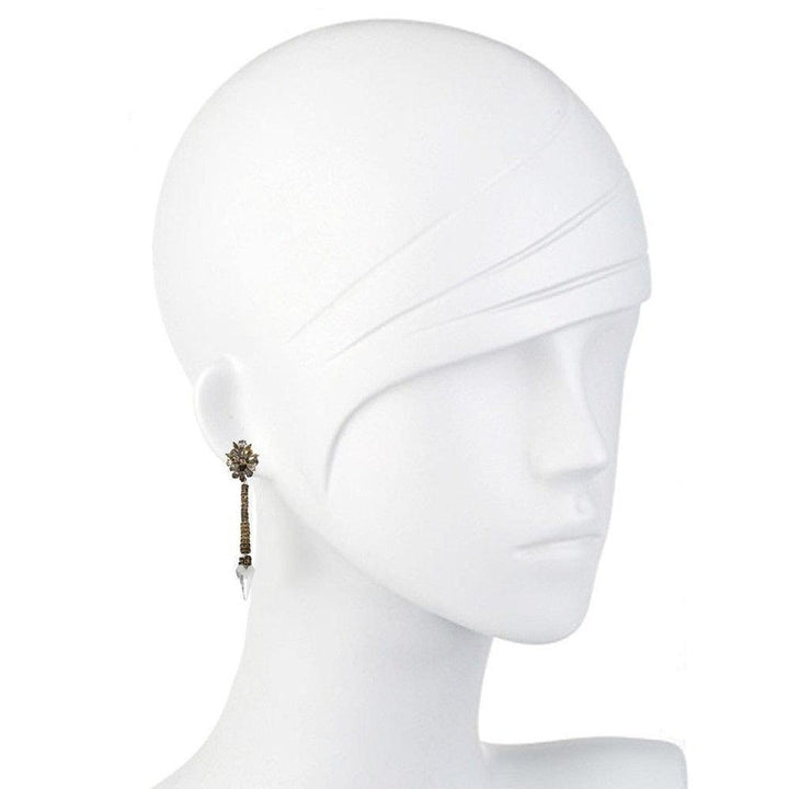 Elegant gold and crystal drop earrings displayed on a white mannequin.