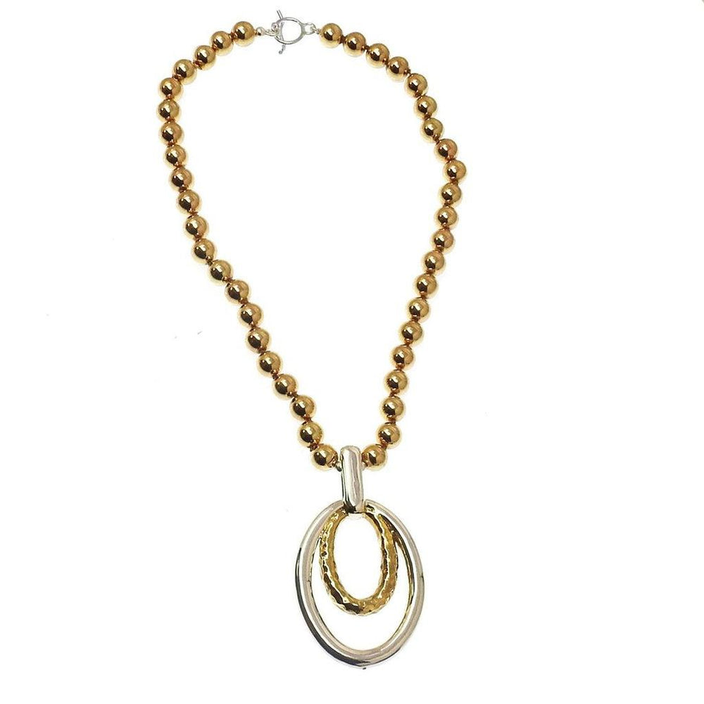 Gold beaded necklace with a silver and gold double oval pendant.