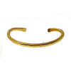 Hammered gold cuff bracelet with textured finish.