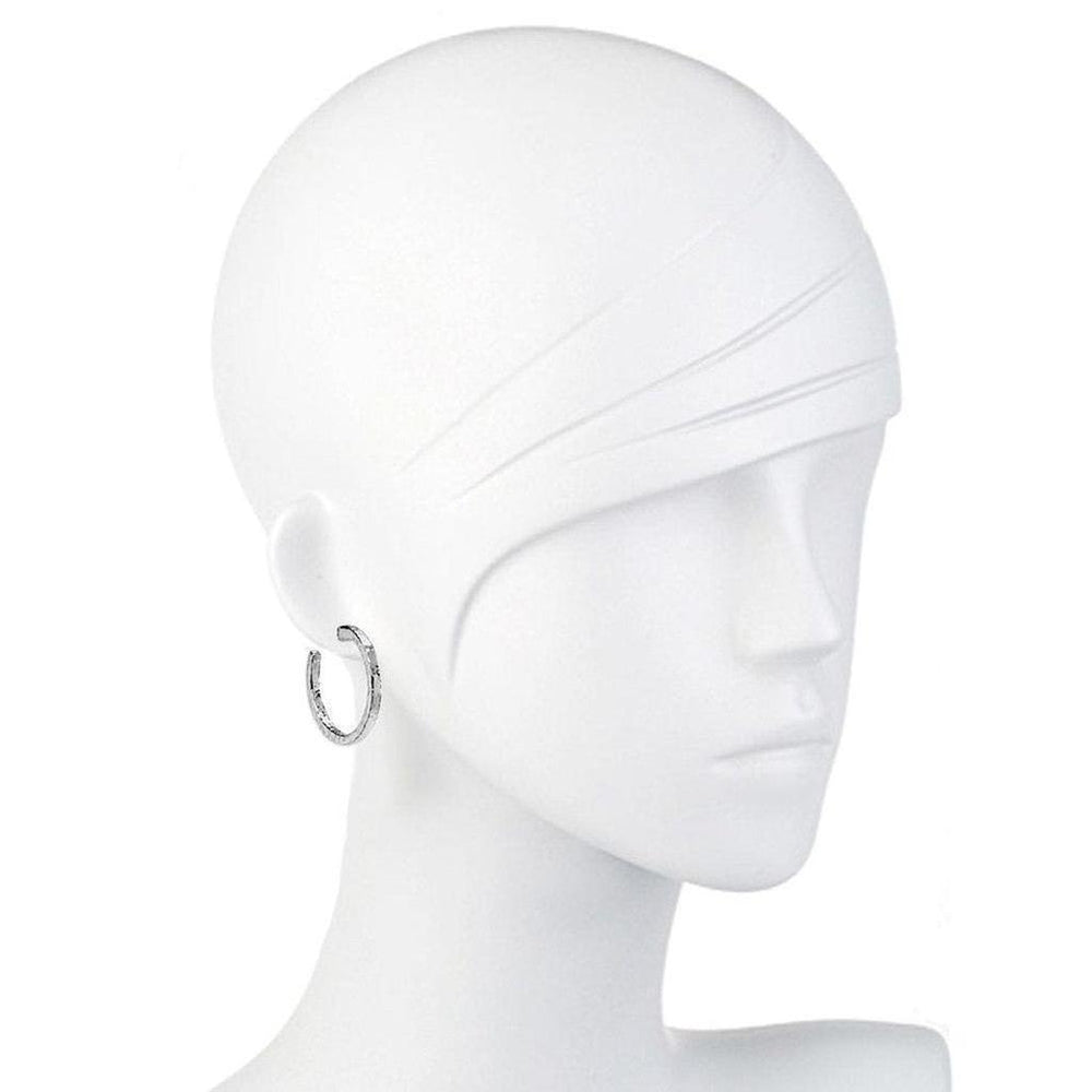Silver hammered hoop earrings on a mannequin.