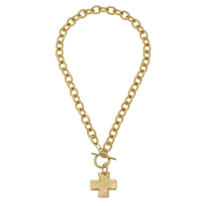 Gold toggle necklace with textured cross pendant on a thick chain.