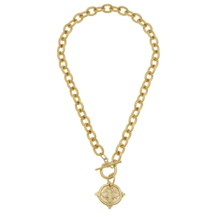 Gold chain necklace featuring a bee medallion pendant.