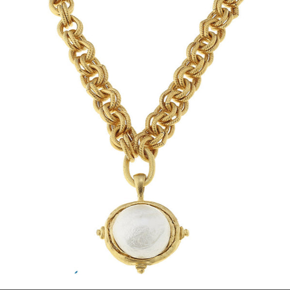 Gold chain necklace with a pendant on a white background