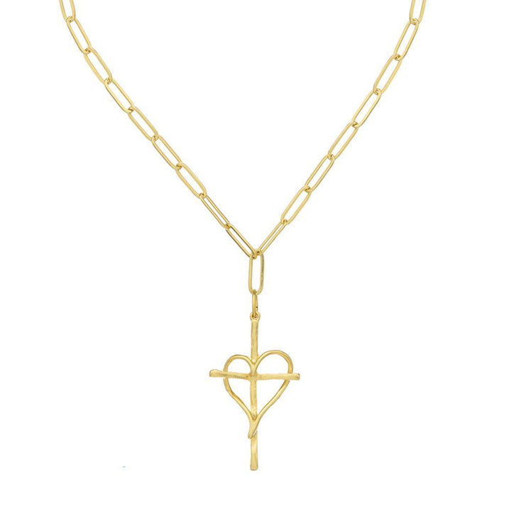 Gold heart cross pendant necklace on a paperclip chain.