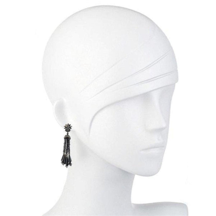 Black hematite beaded tassel earrings on a mannequin.