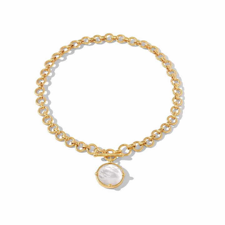 Gold chain necklace with a circular mother-of-pearl pendant.