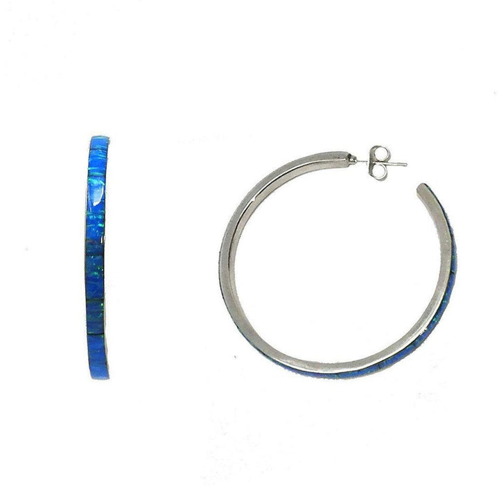 Silver hoop earrings featuring a vibrant blue opal inlay.