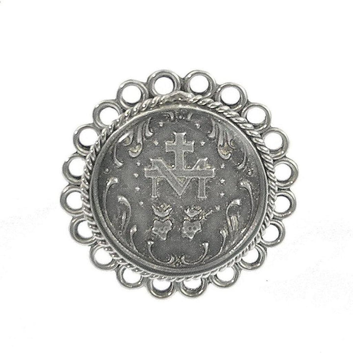 Silver ring featuring an ornate circular design, centered with a religious medallion.