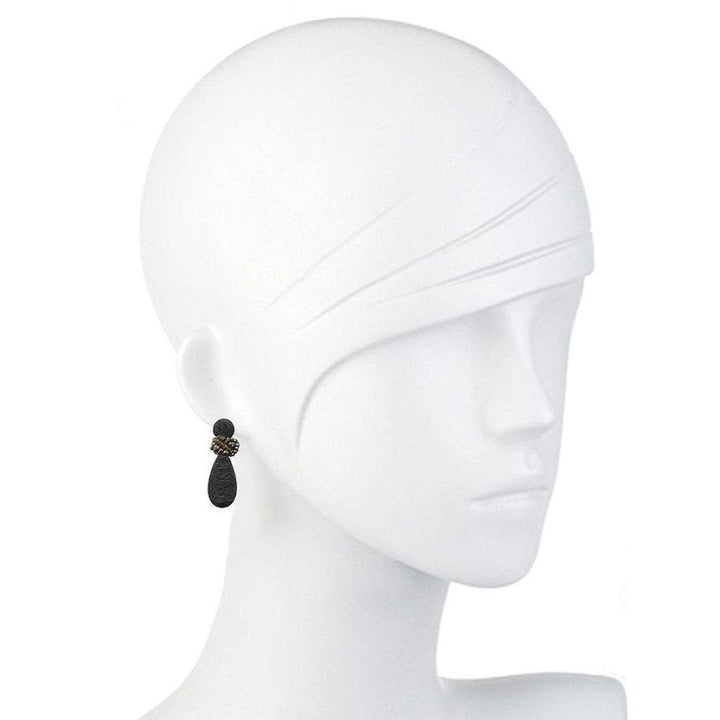 Black teardrop earrings with beaded detail on a mannequin.