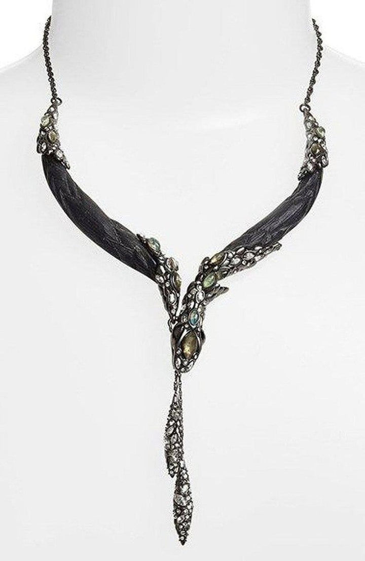 Dark, ornate snake necklace with gemstone accents, displayed on a mannequin.
