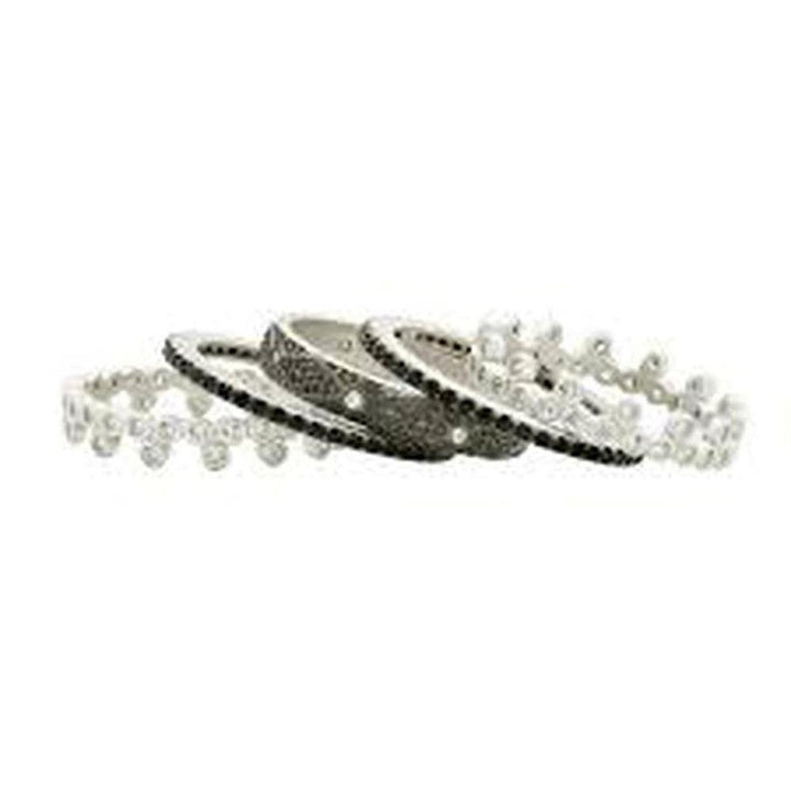 Five sparkling rings, black and white, arranged on a white background.