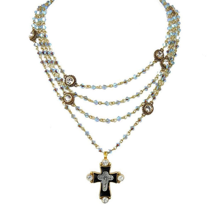 Multi-strand necklace featuring iridescent blue crystals, gold accents, and a black cross pendant.