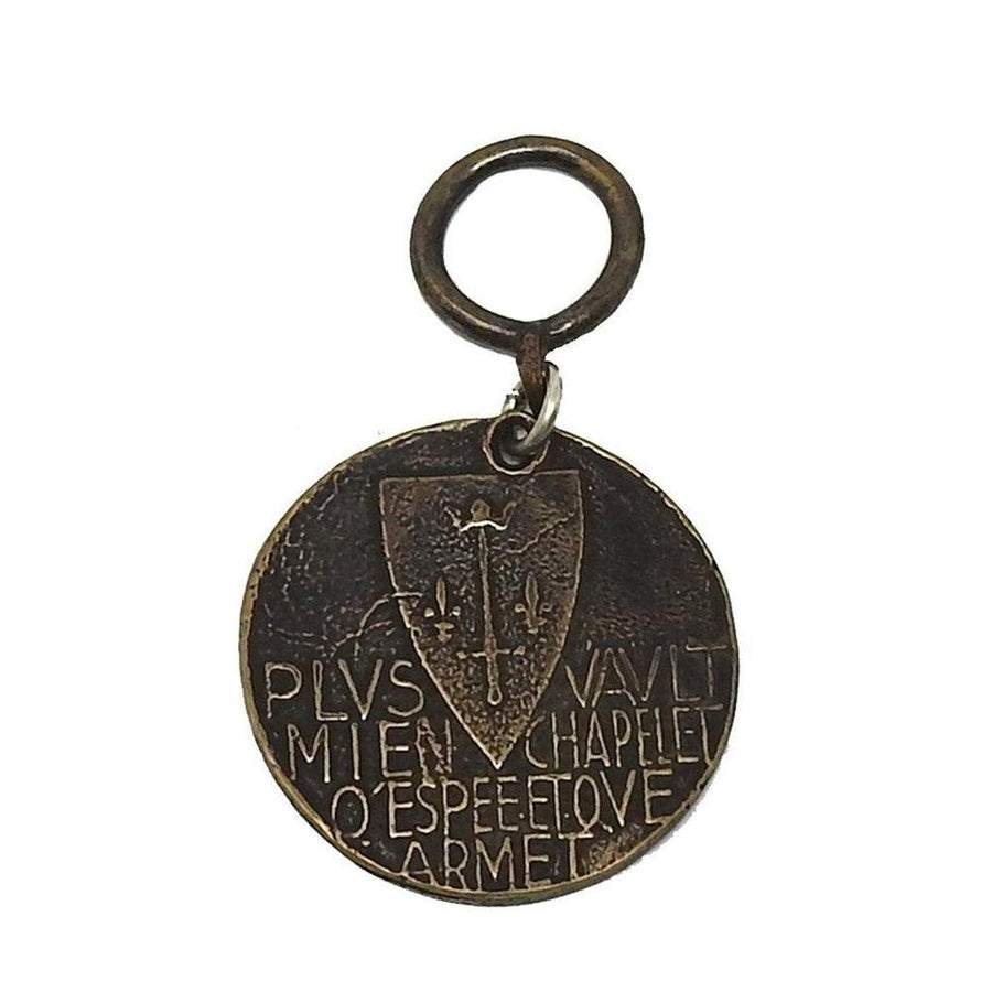 Joan of Arc medallion, bronze, featuring shield and Latin inscription.