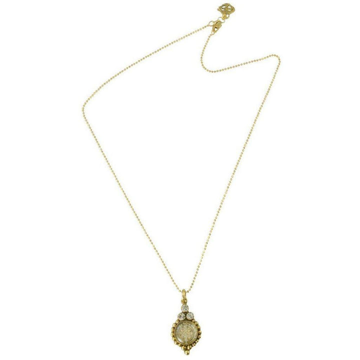 Gold chain necklace with ornate pendant featuring a clear stone and tiny accents.