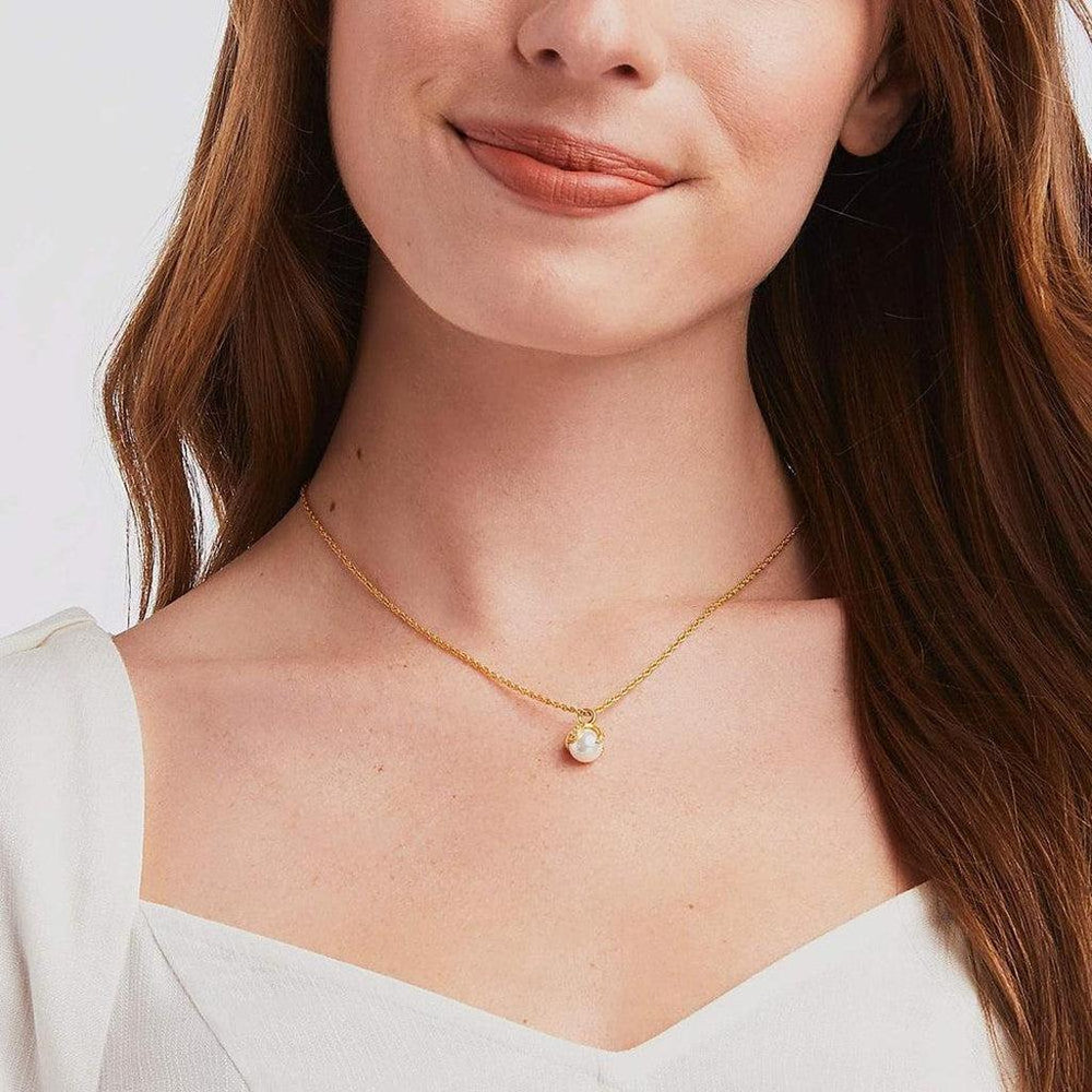 Gold chain necklace featuring a delicate pearl pendant.