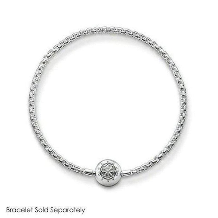Silver charm featuring an ornate design, shown on a delicate chain bracelet (bracelet sold separately).
