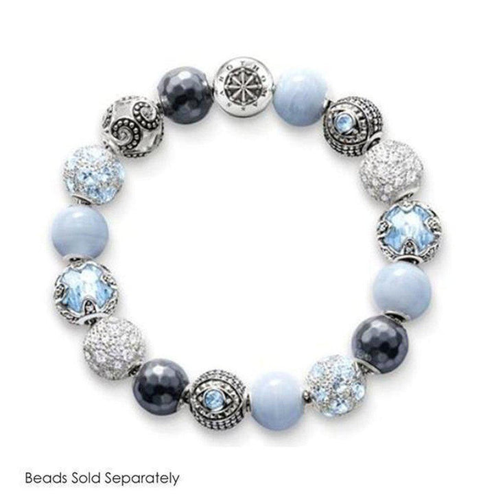 Elegant beaded bracelet featuring pale blue and gray stones, silver accents, and a compass charm.