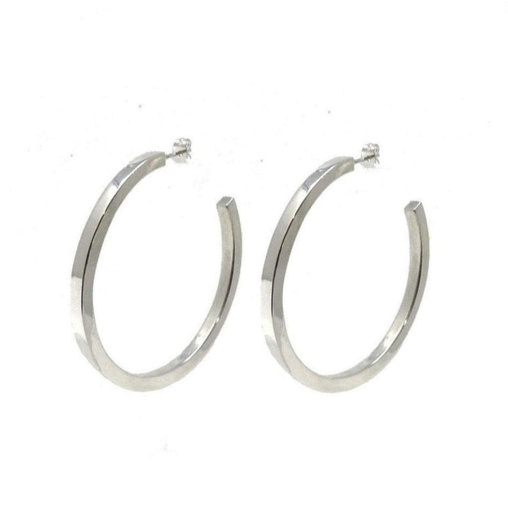 Silver large hoop earrings; modern, minimalist design.