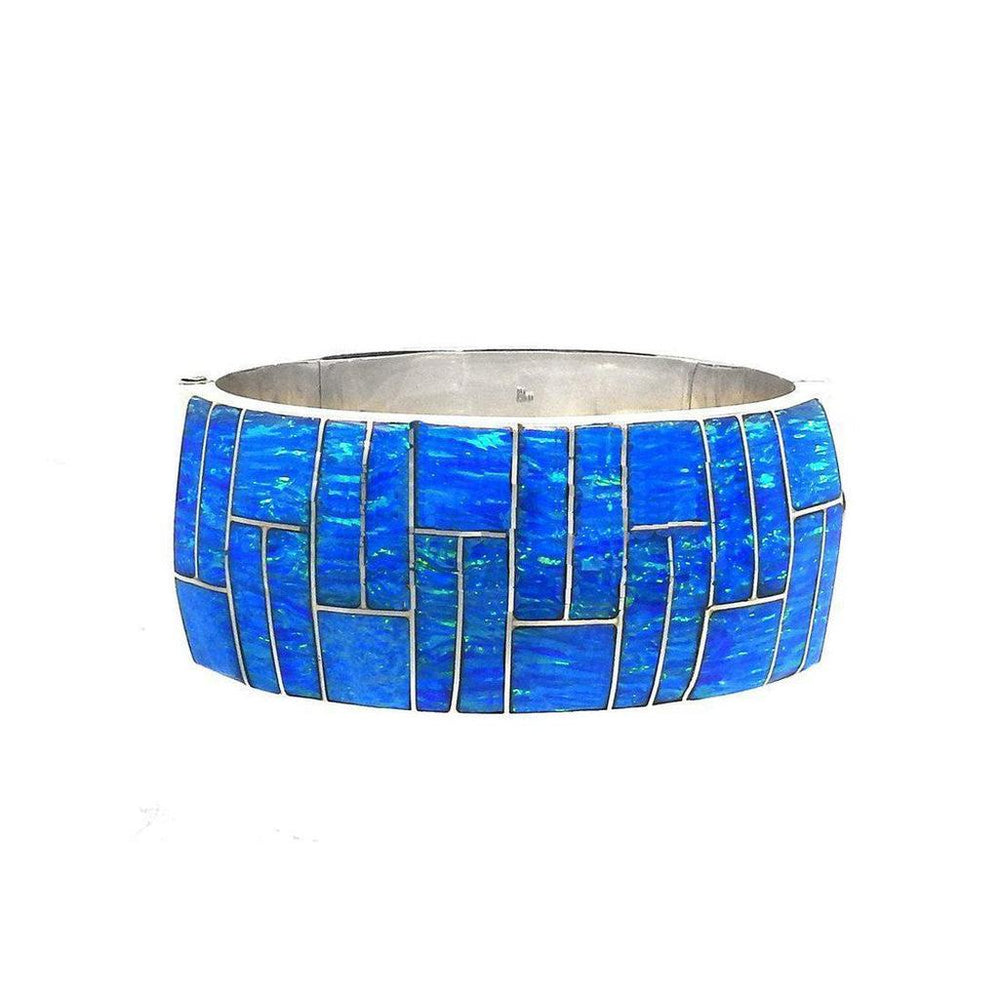 Wide blue opal inlay bracelet with geometric silver setting.