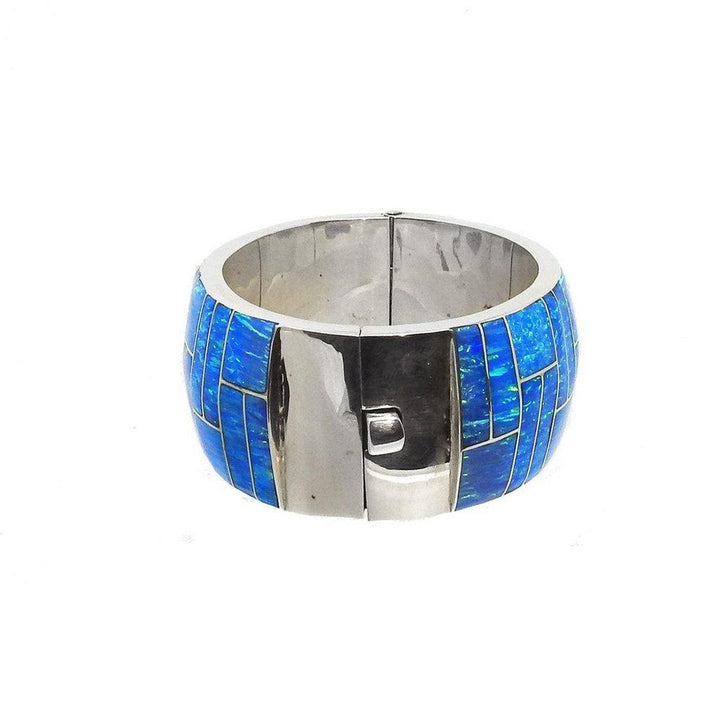 Blue opal inlay hinged bangle bracelet in sterling silver.