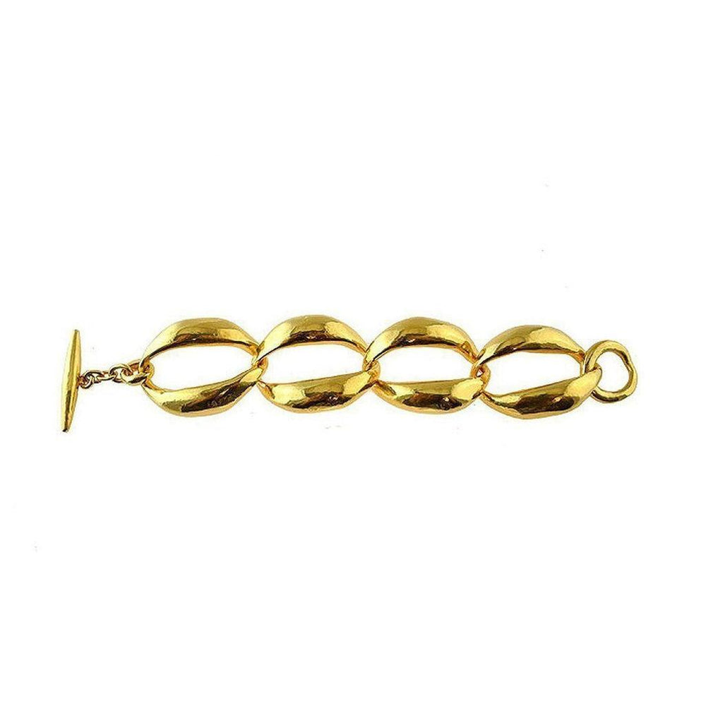 Gold statement bracelet featuring a bold, linked chain design.