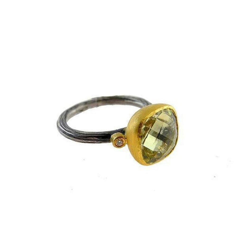 Elegant gold and oxidized silver ring featuring a pale green lemon quartz and a small diamond accent.