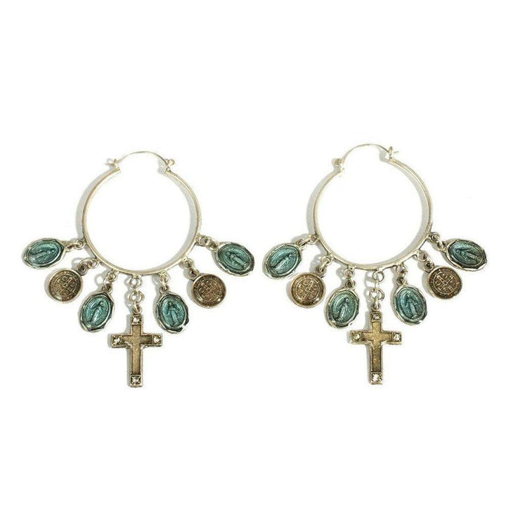 Silver hoop earrings adorned with turquoise and gold medallions, plus a cross charm.