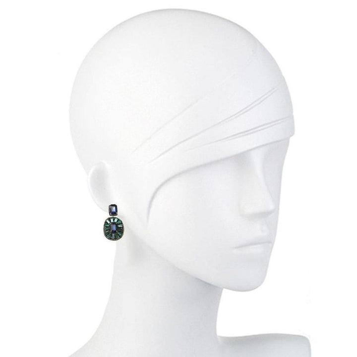Elegant drop earrings with blue and green gemstone accents on a mannequin.