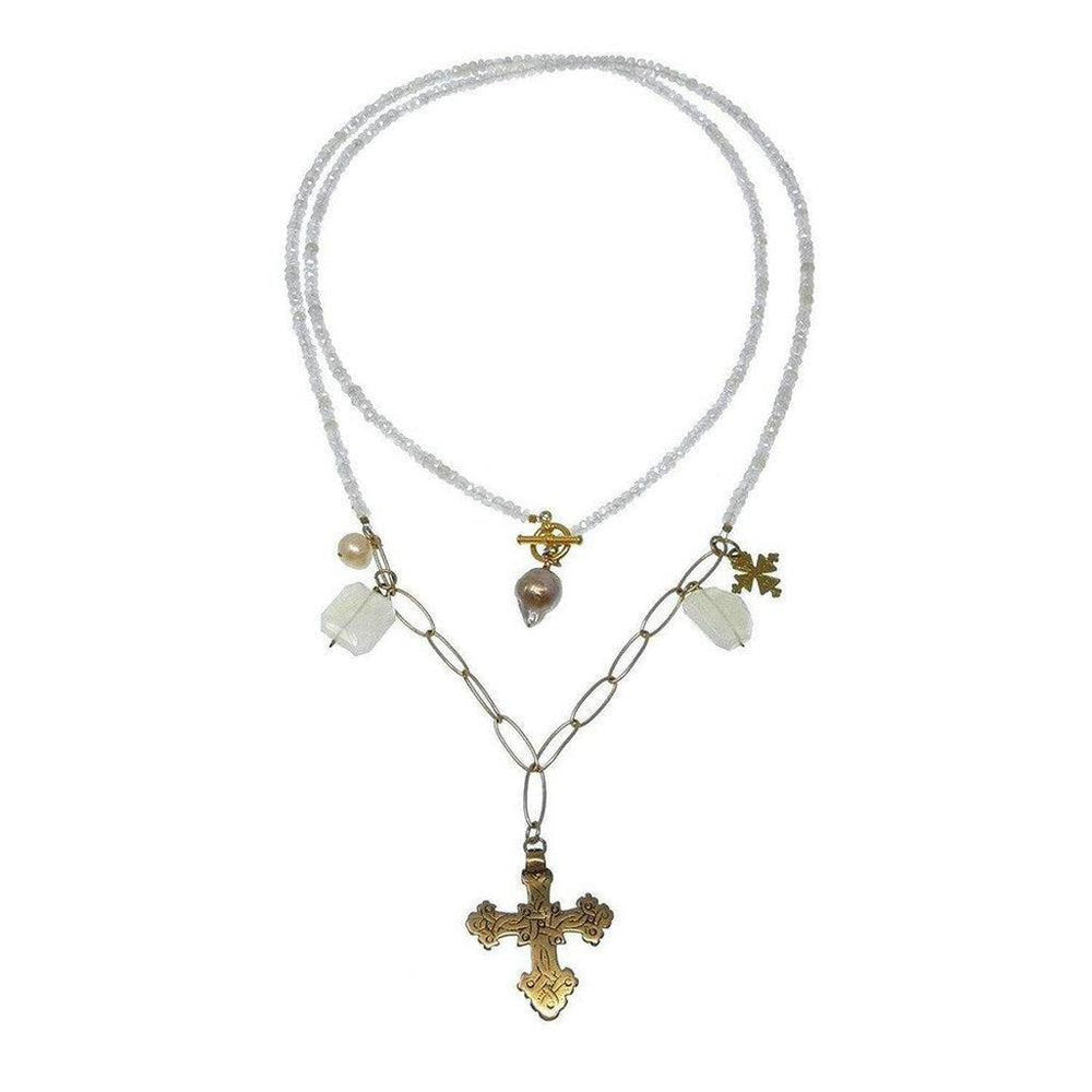 Layered beaded necklace with a gold cross pendant and pearl accents.
