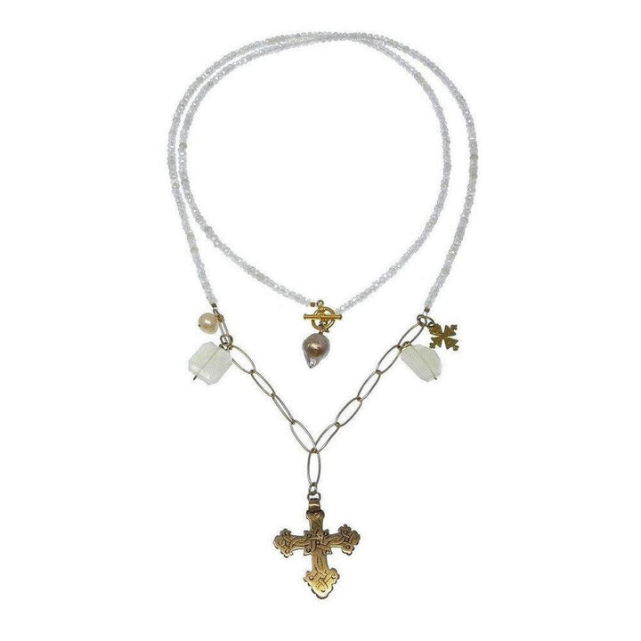Layered beaded necklace with a gold cross pendant and pearl accents.