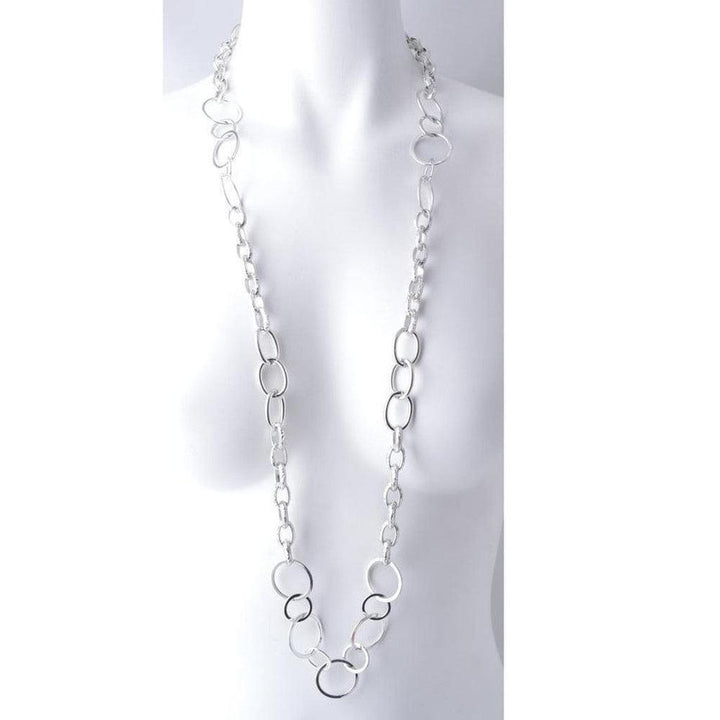 Long silver chain necklace with oversized oval links, displayed on a mannequin.