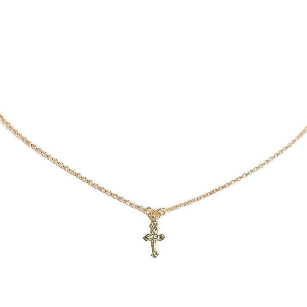 Dainty gold chain necklace with a small, ornate cross pendant.