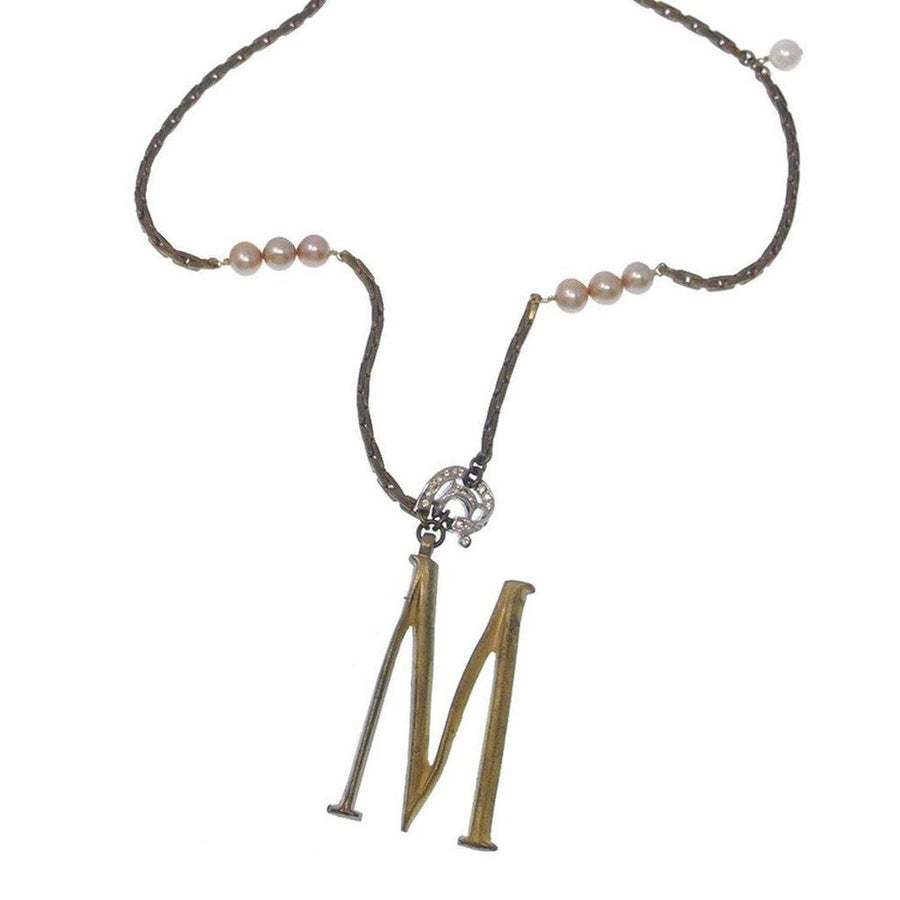Lulu Frost Plaza Letter M Necklace: gold initial M pendant with bronze chain and blush pearls.