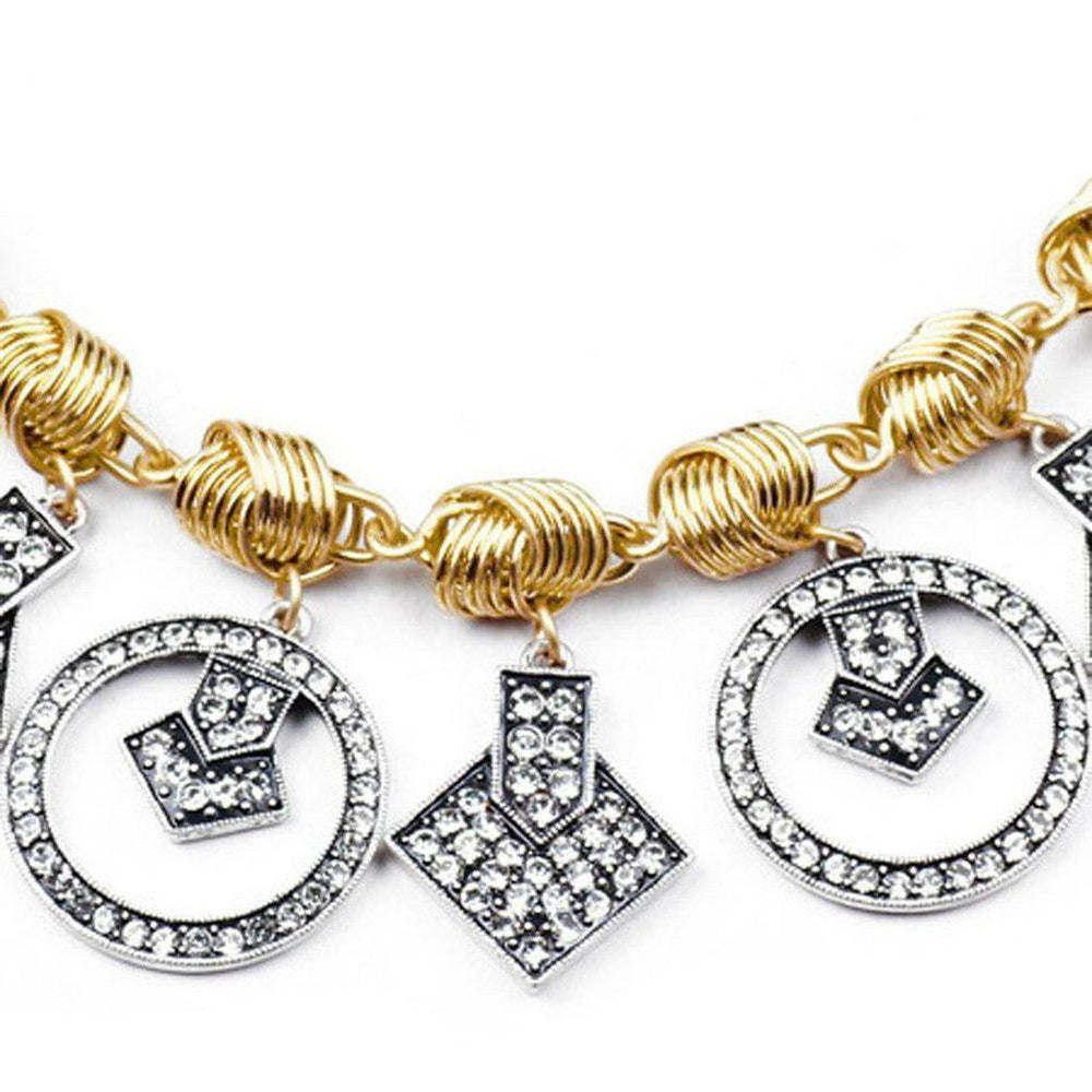 Gold chain necklace with dangling geometric crystal charms.