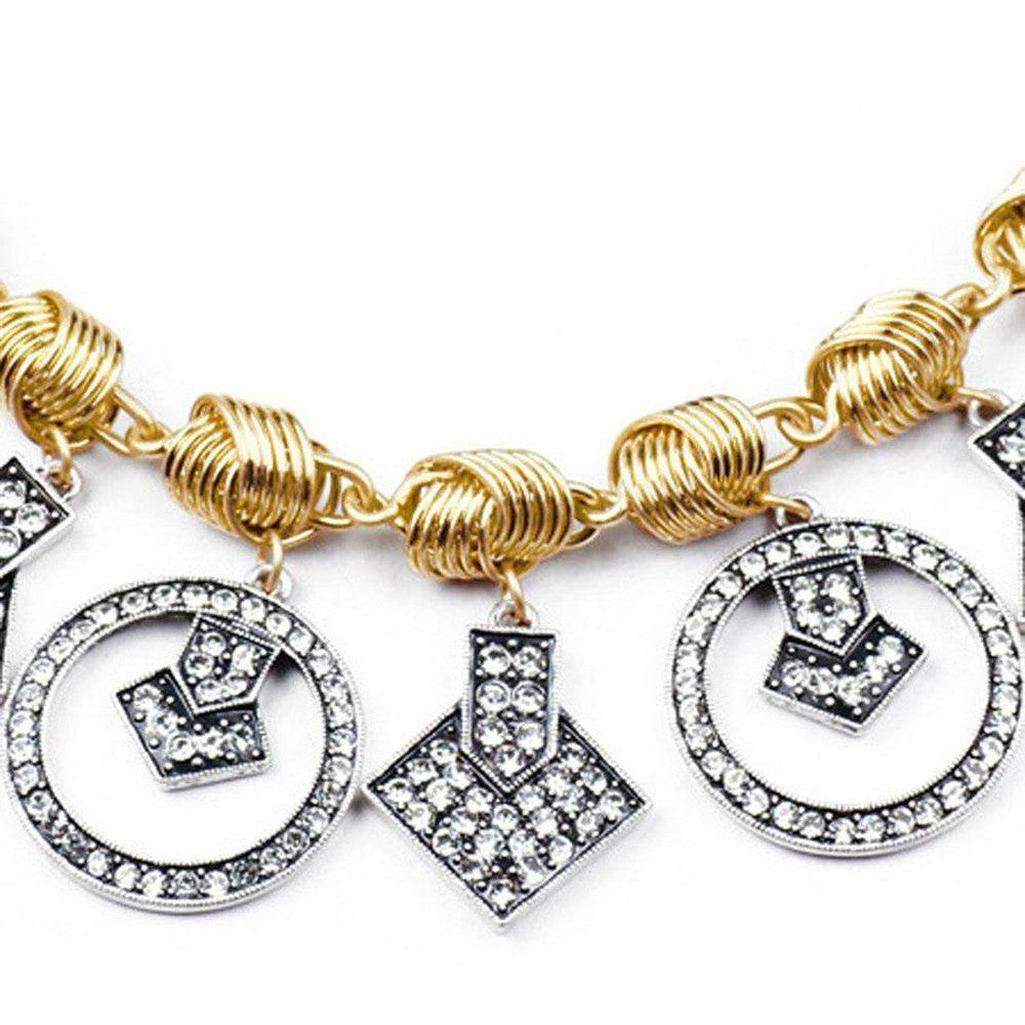Gold chain necklace with dangling geometric crystal charms.