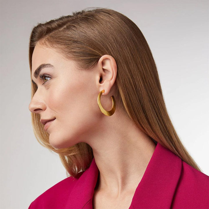 Gold statement hoops on a woman, close-up view.