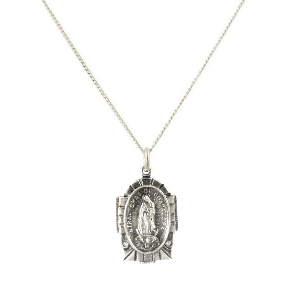 Silver necklace featuring an oval religious pendant with intricate detailing.