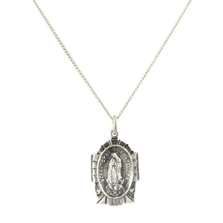 Silver necklace featuring an oval religious pendant with intricate detailing.