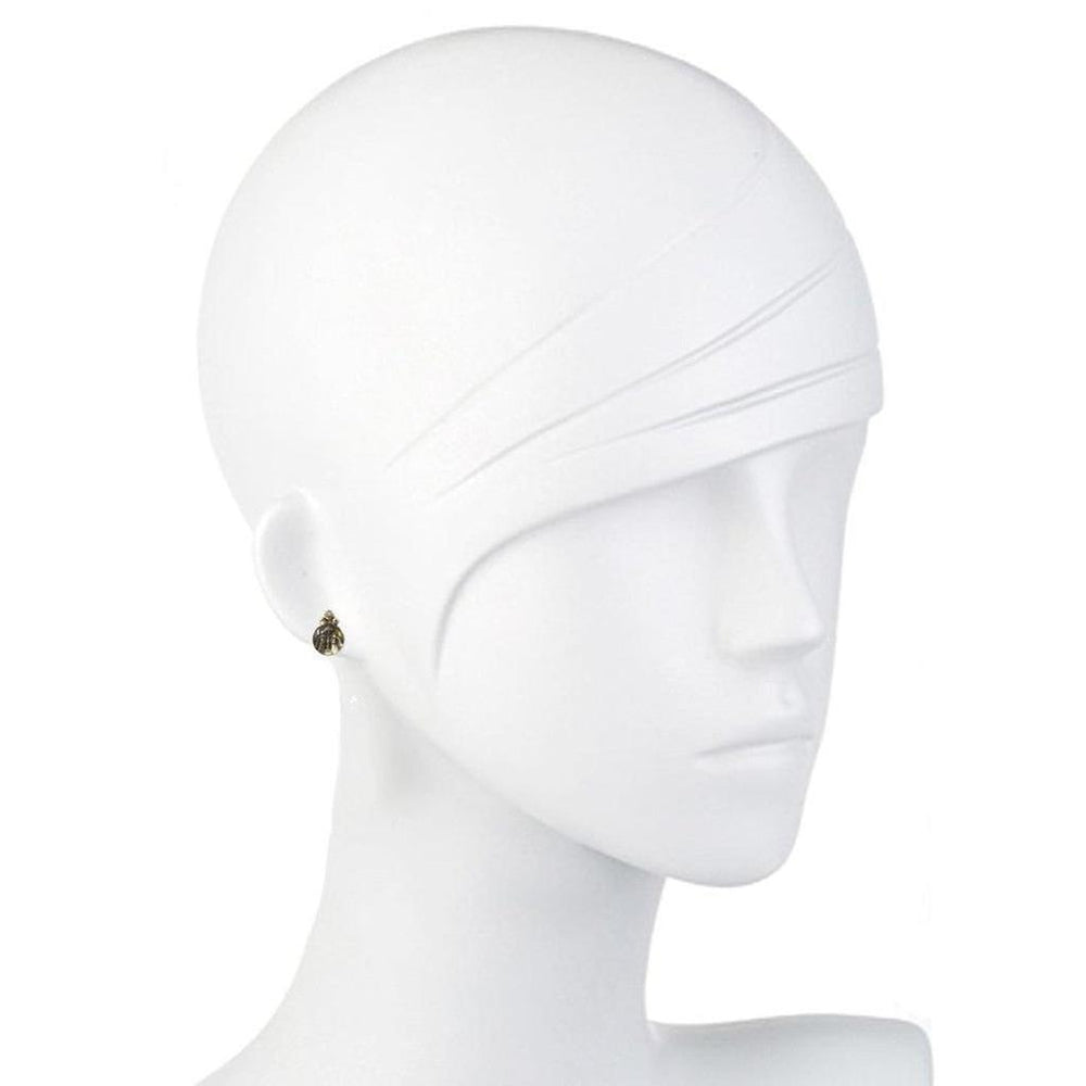 Small gold guardian angel post earrings on a white mannequin.