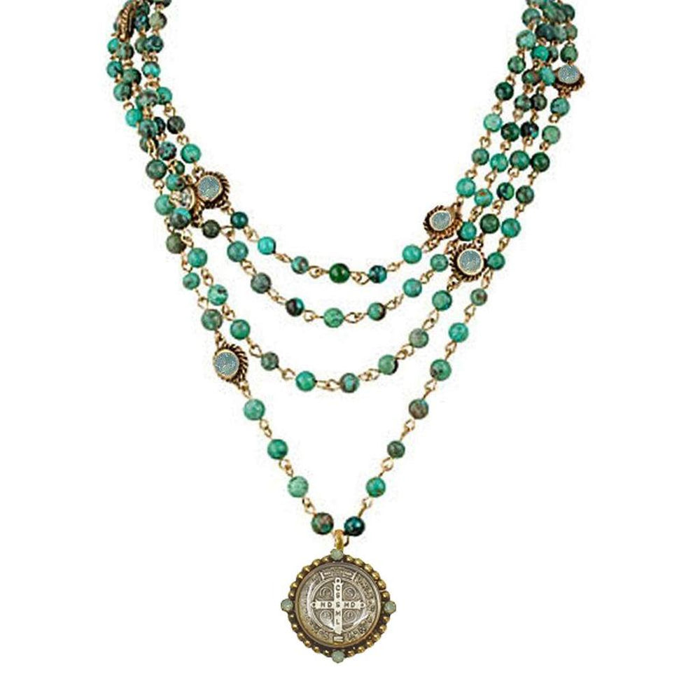 Multi-strand turquoise bead necklace with antique coin pendant.