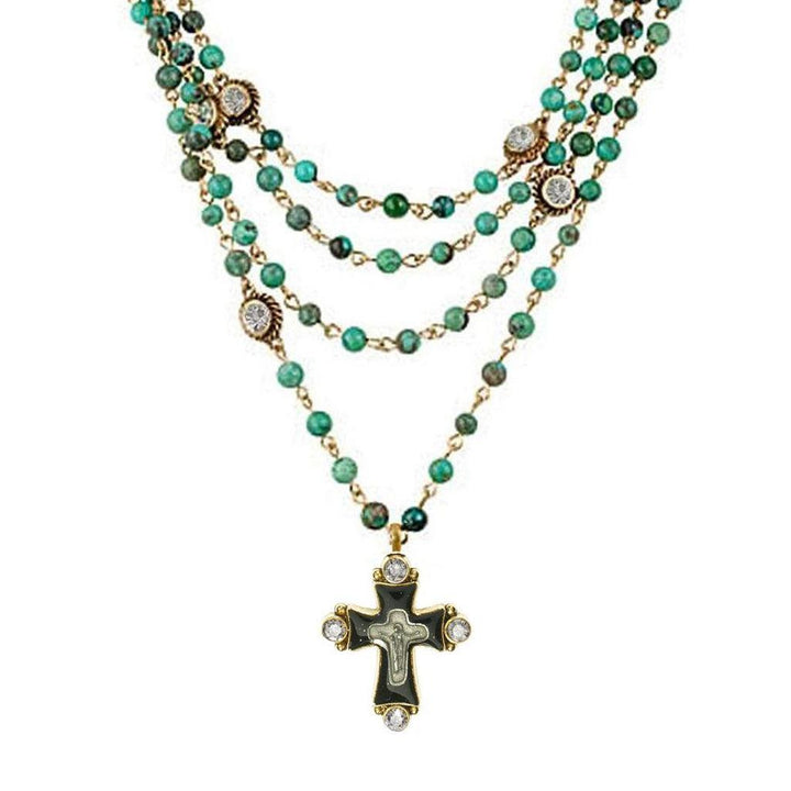 Multi-strand turquoise bead necklace with gold accents and a detailed cross pendant.