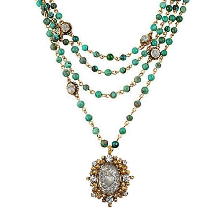 Multi-strand turquoise bead necklace with gold accents and a silver heart charm.