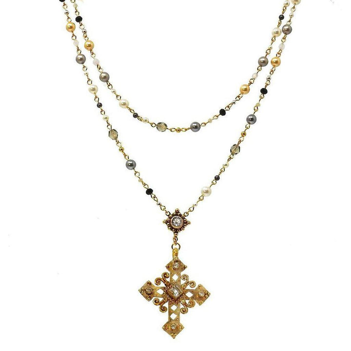 Layered pearl and gemstone rosary necklace with ornate gold cross pendant.