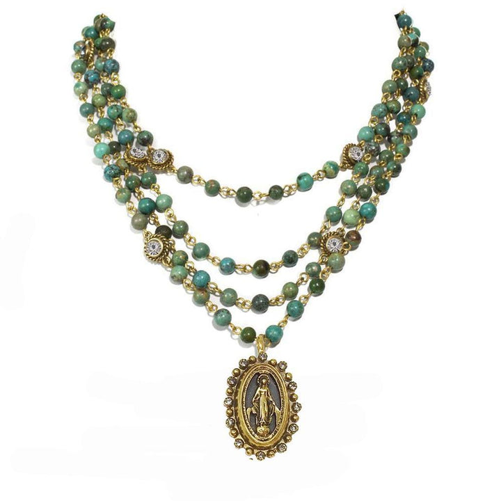 Three-strand turquoise bead necklace with gold accents and Virgin Mary pendant.