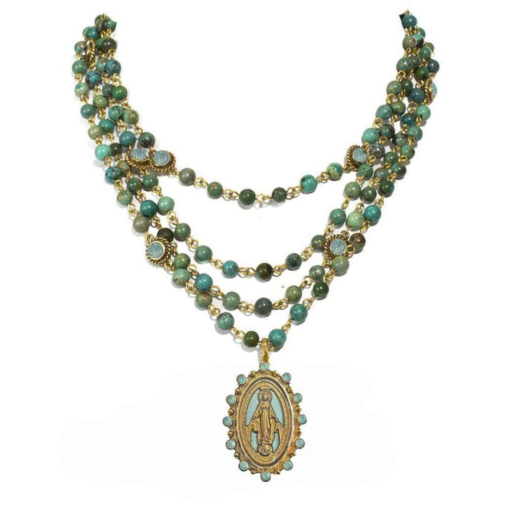 Three-strand turquoise beaded necklace with gold accents and a Virgin Mary medallion pendant.