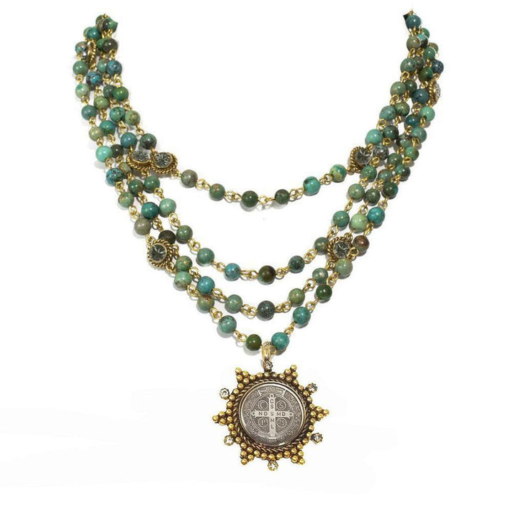 Three-strand turquoise bead necklace with gold accents and a detailed medal pendant.