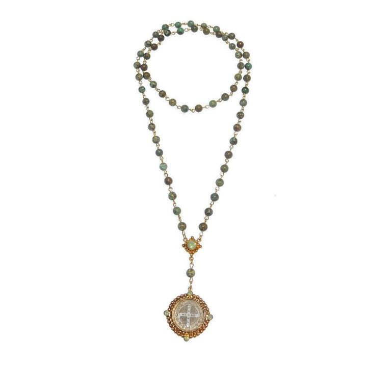 Turquoise rosary necklace with gold accents and a detailed medallion.
