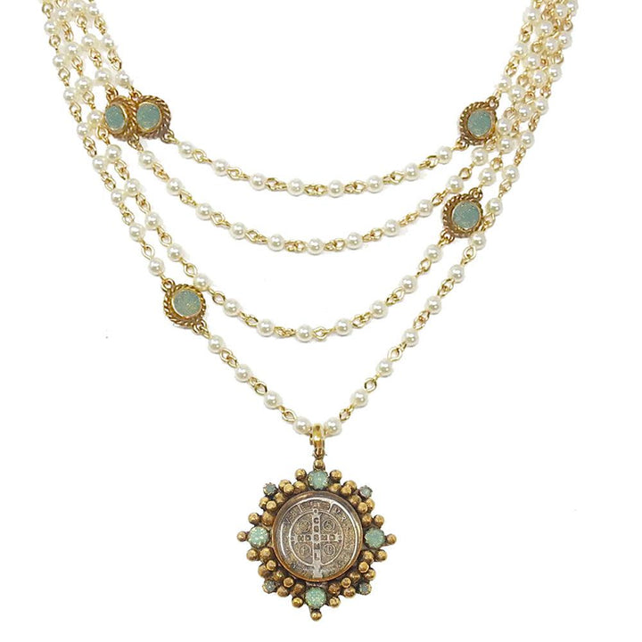 Multi-strand pearl necklace with gold accents and a detailed medallion pendant.